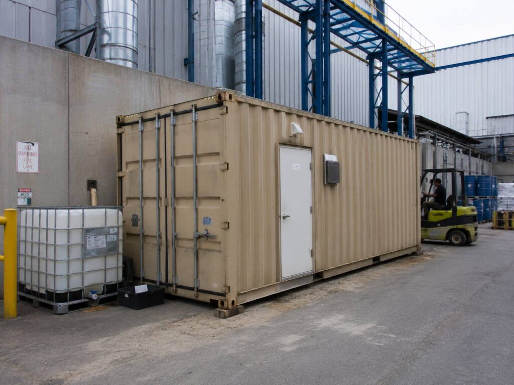 Modified shipping container with a door used as an industrial unit at a factory